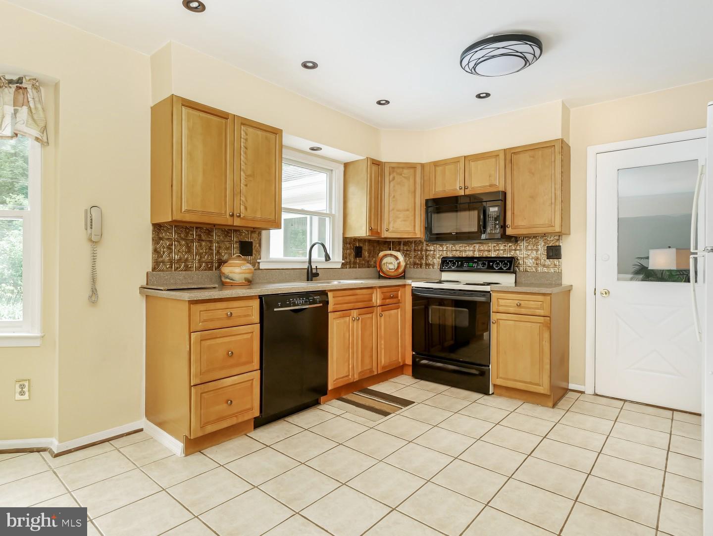 281 Cliveden Drive Newtown, PA 18940 - Photo 18 of 35 a kitchen with a stove a sink and a refrigerator