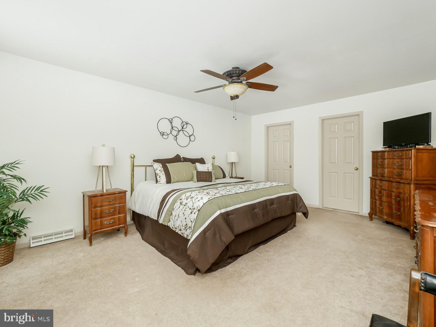 281 Cliveden Drive Newtown, PA 18940 - Photo 26 of 35 a bedroom with a bed and a chandelier