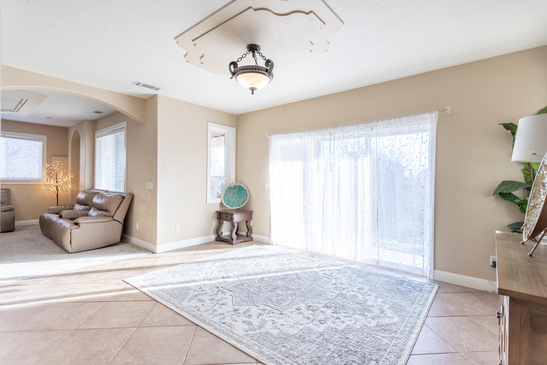 7775 Muletown Road Redding, CA 96001 - Photo 20 of 46 a spacious bedroom with a bed and a chandelier