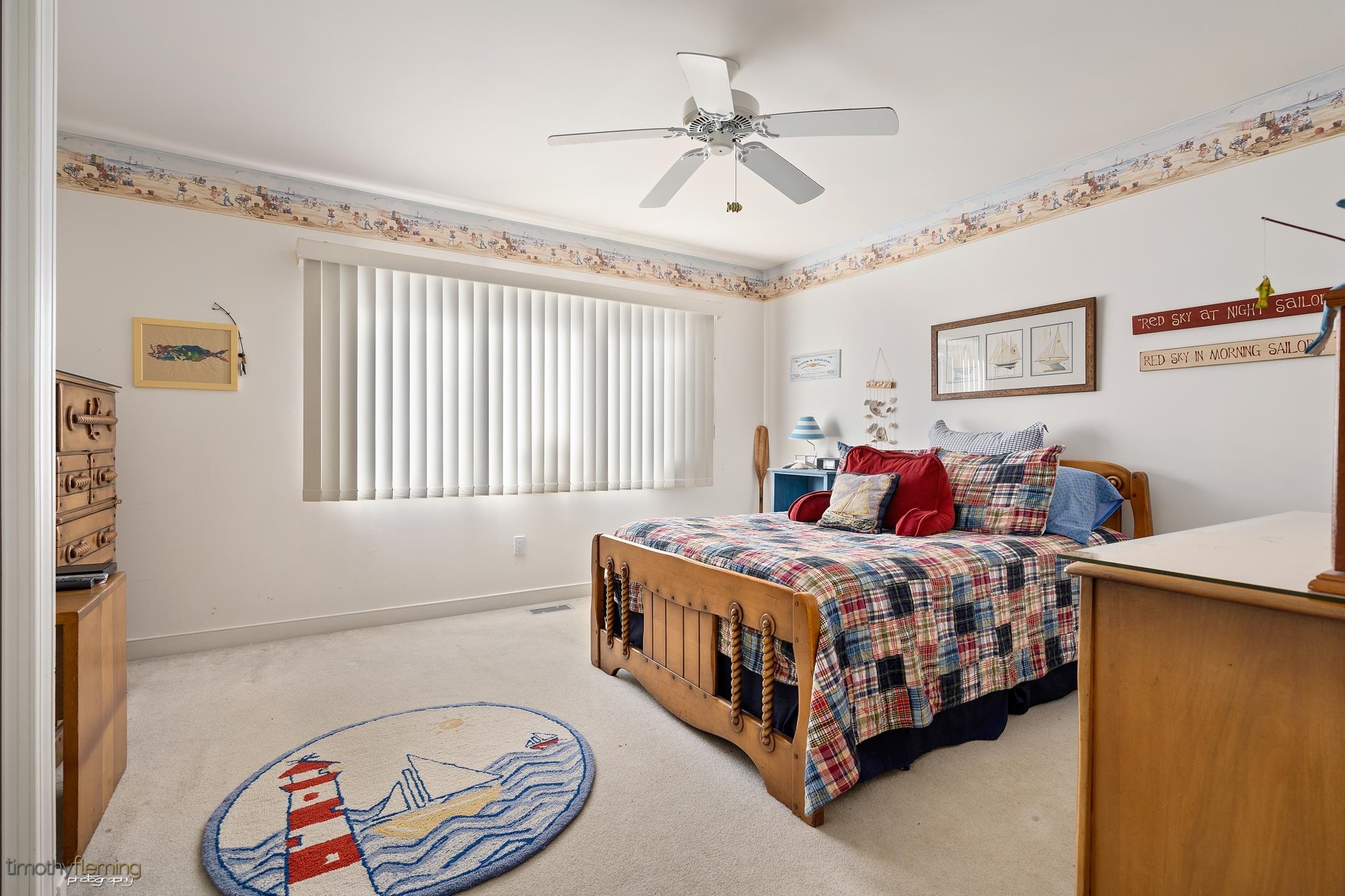 13 12th Street Avalon, NJ 08202 - Photo 12 of 24 a bedroom with a bed and a chandelier