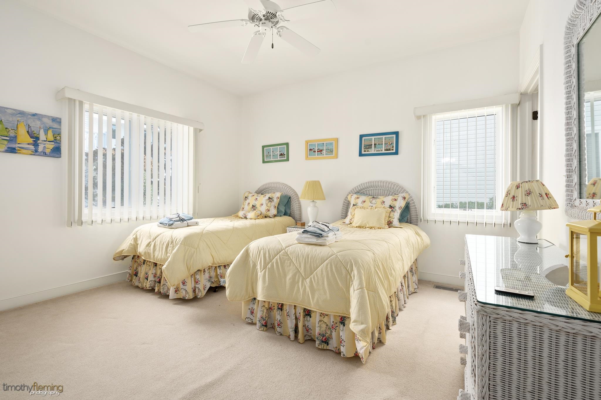 13 12th Street Avalon, NJ 08202 - Photo 18 of 24 a spacious bedroom with two beds and a chandelier
