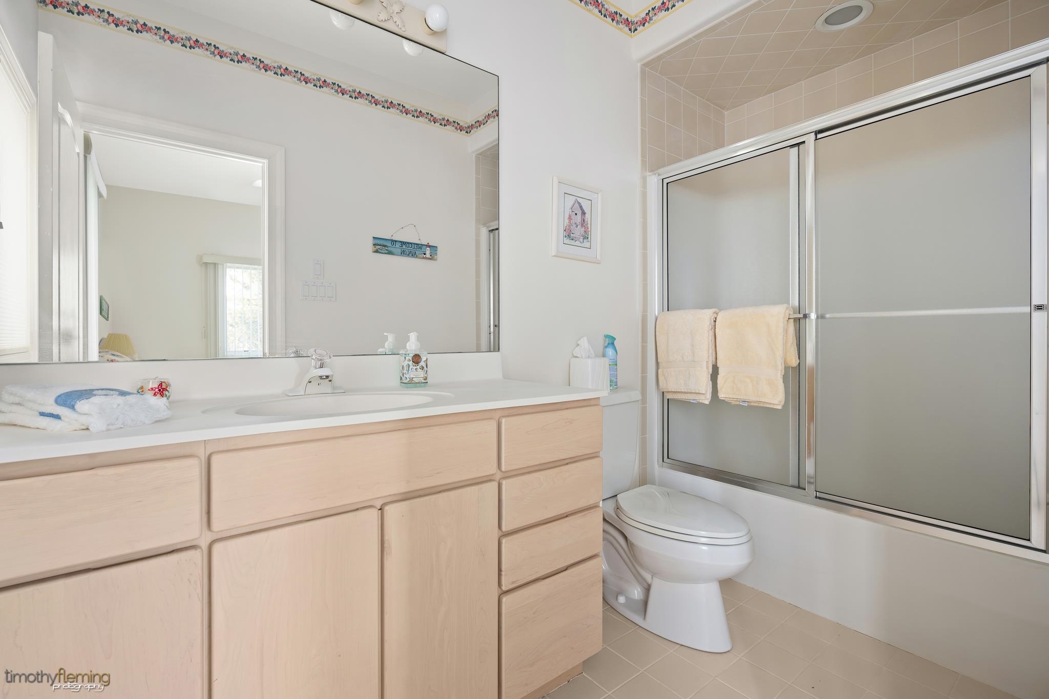 13 12th Street Avalon, NJ 08202 - Photo 19 of 24 a bathroom with a toilet sink vanity and mirror