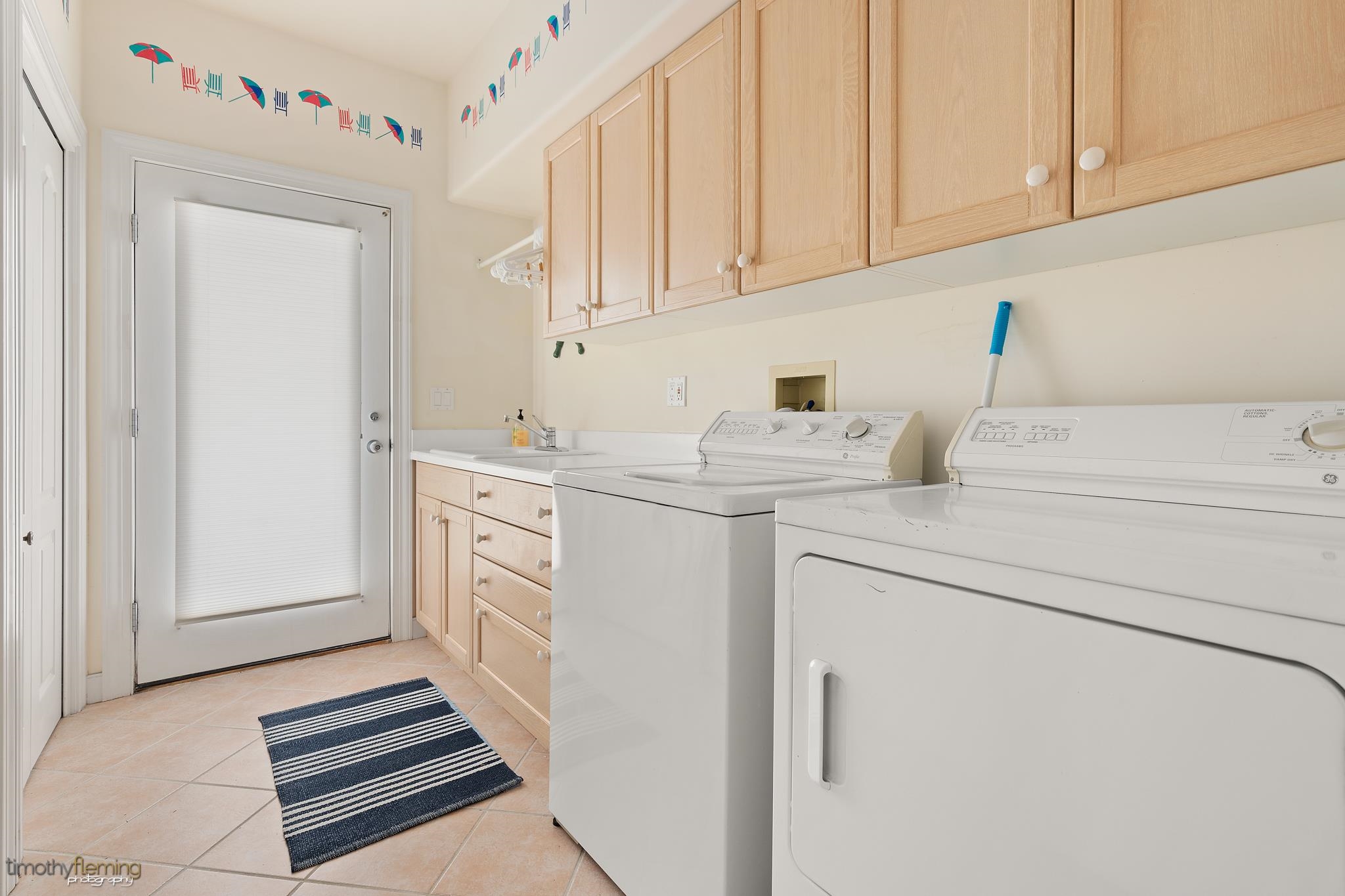 13 12th Street Avalon, NJ 08202 - Photo 20 of 24 a kitchen with white cabinets and white appliances