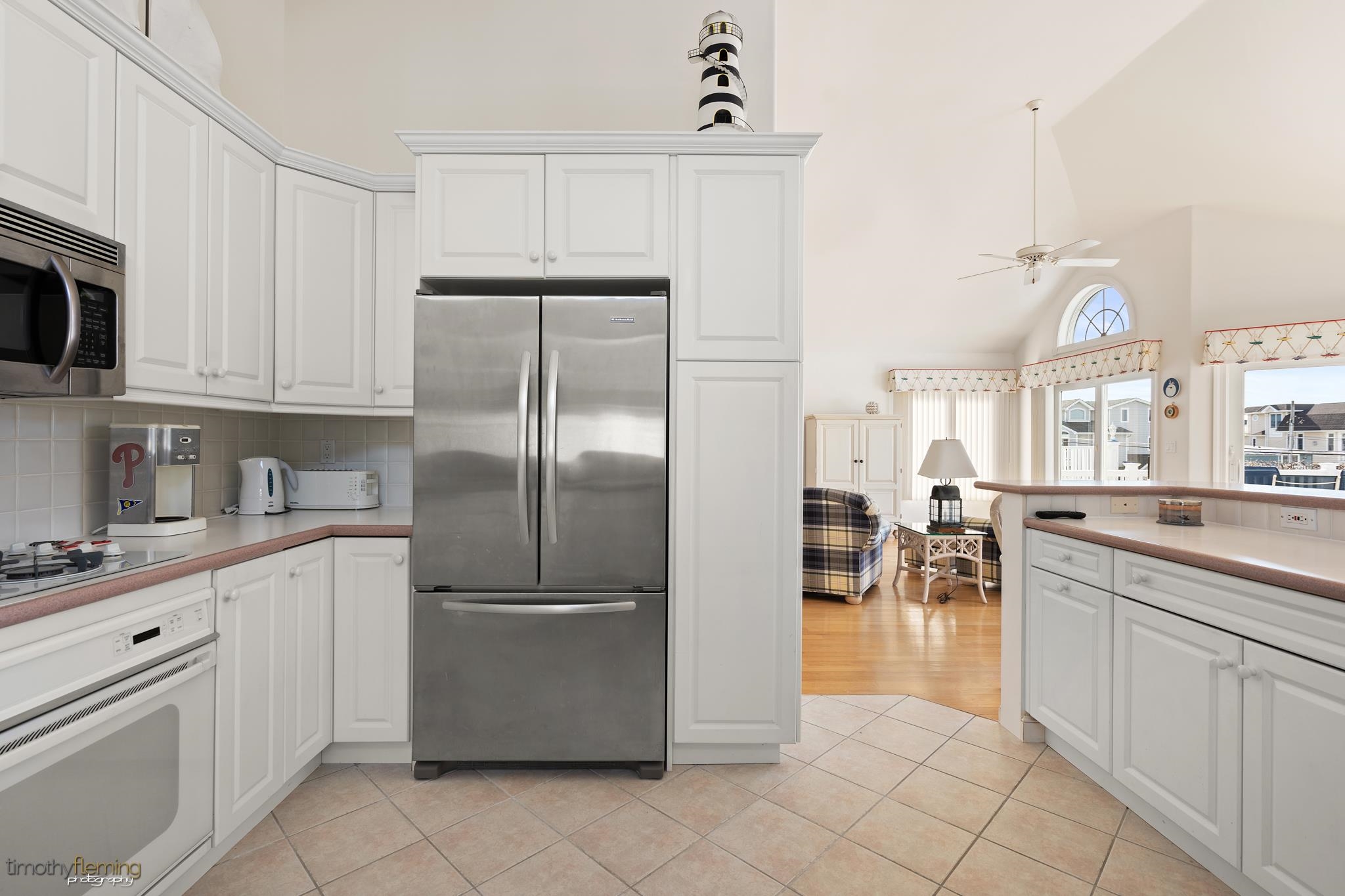 13 12th Street Avalon, NJ 08202 - Photo 4 of 24 a kitchen with white cabinets and appliances