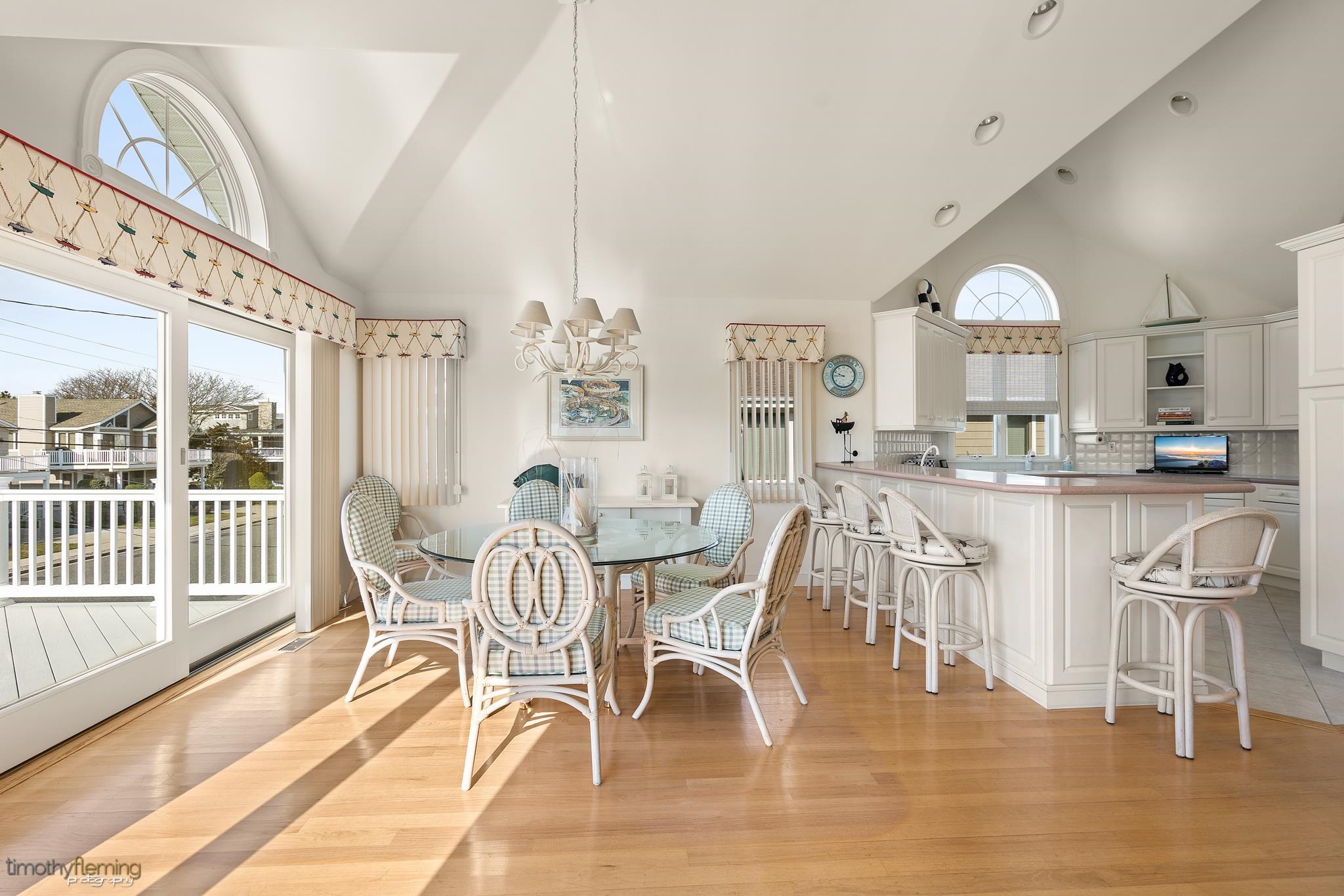 13 12th Street Avalon, NJ 08202 - Photo 6 of 24 a view of a dining room with furniture a chandelier and wooden floor