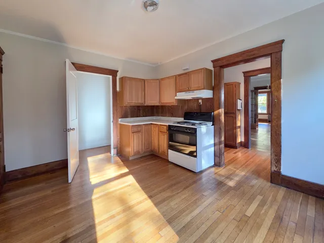 a kitchen with granite countertop a stove top oven and cabinets