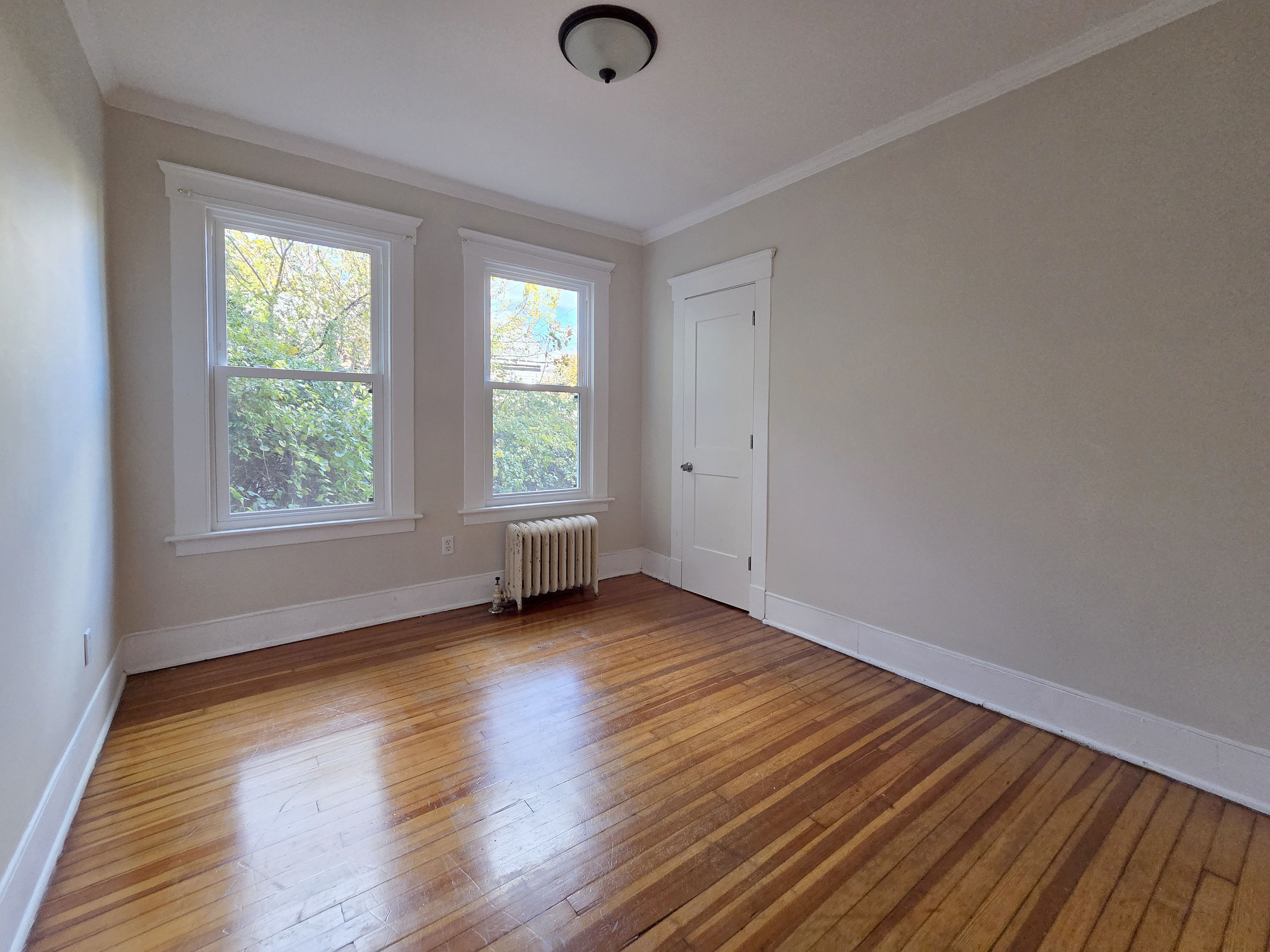 302 Lexington Avenue New Haven, CT 06513 - Photo 19 of 24 an empty room with wooden floor and windows
