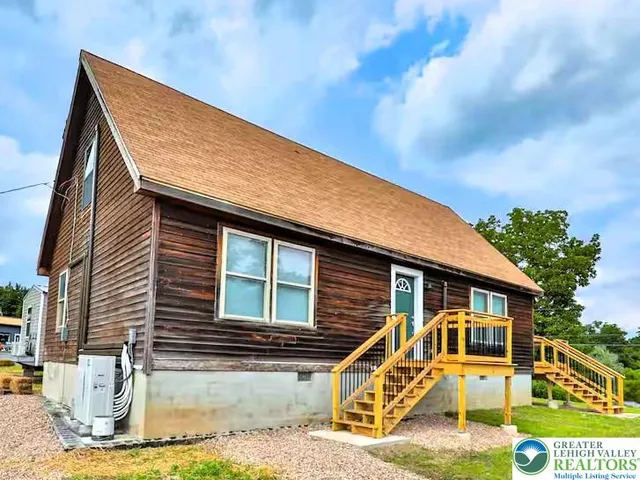 a view of a house with a wooden fence