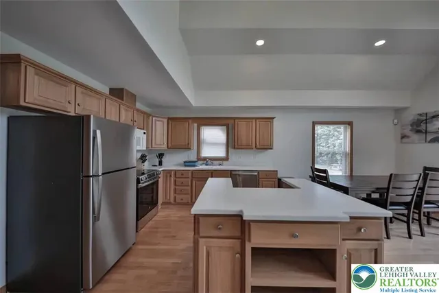 a kitchen with a appliances a refrigerator and a stove top oven