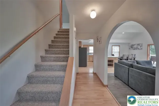 a living room with furniture and stairs