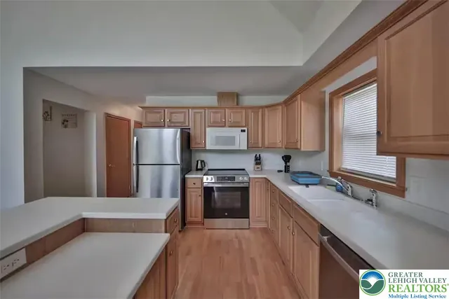 a kitchen with refrigerator cabinets and a sink