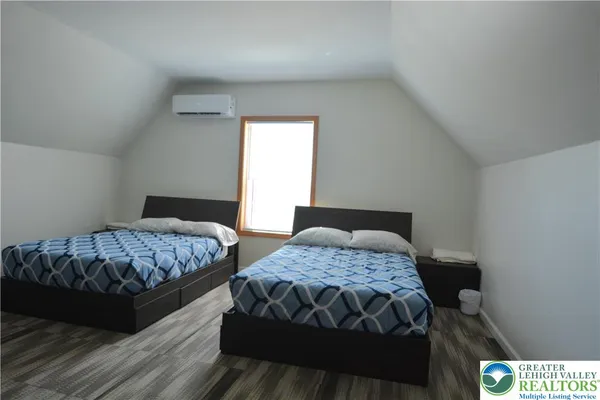 a bedroom with two beds and a window