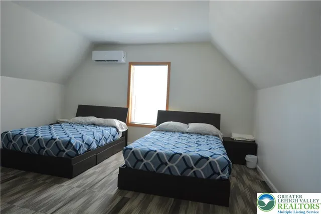 a bedroom with two beds and a window