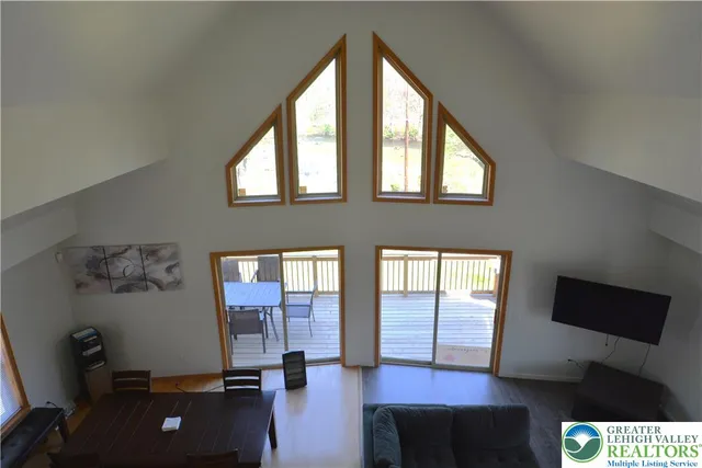 a living room with furniture and a floor to ceiling window
