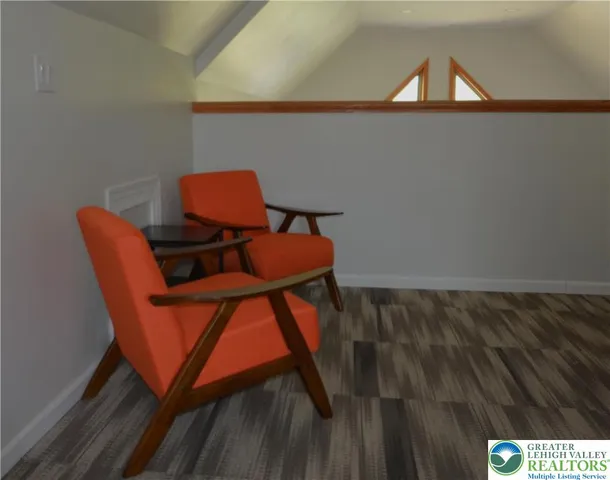 a balcony with a chair and white walls