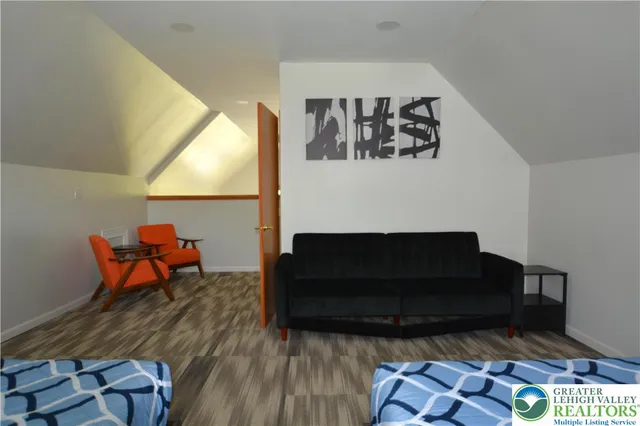 a living room with furniture a rug and a wooden floor