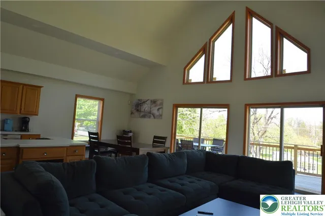 a view of a house with swimming pool and sitting area