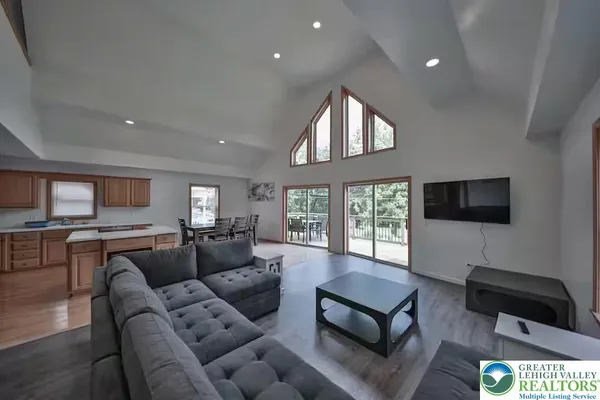 a living room with furniture ceiling fan and a window