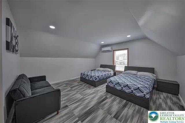 a bedroom with two beds and painted walls