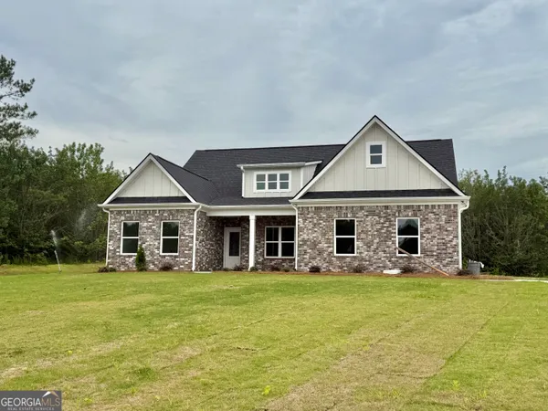 a front view of house with yard and glass windows