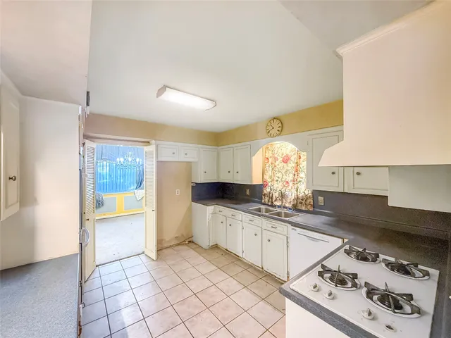 a kitchen with a sink cabinets and window