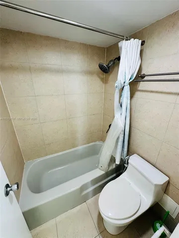 a bathroom with a toilet and a bathtub