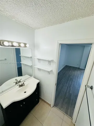 a bathroom with a sink and mirror