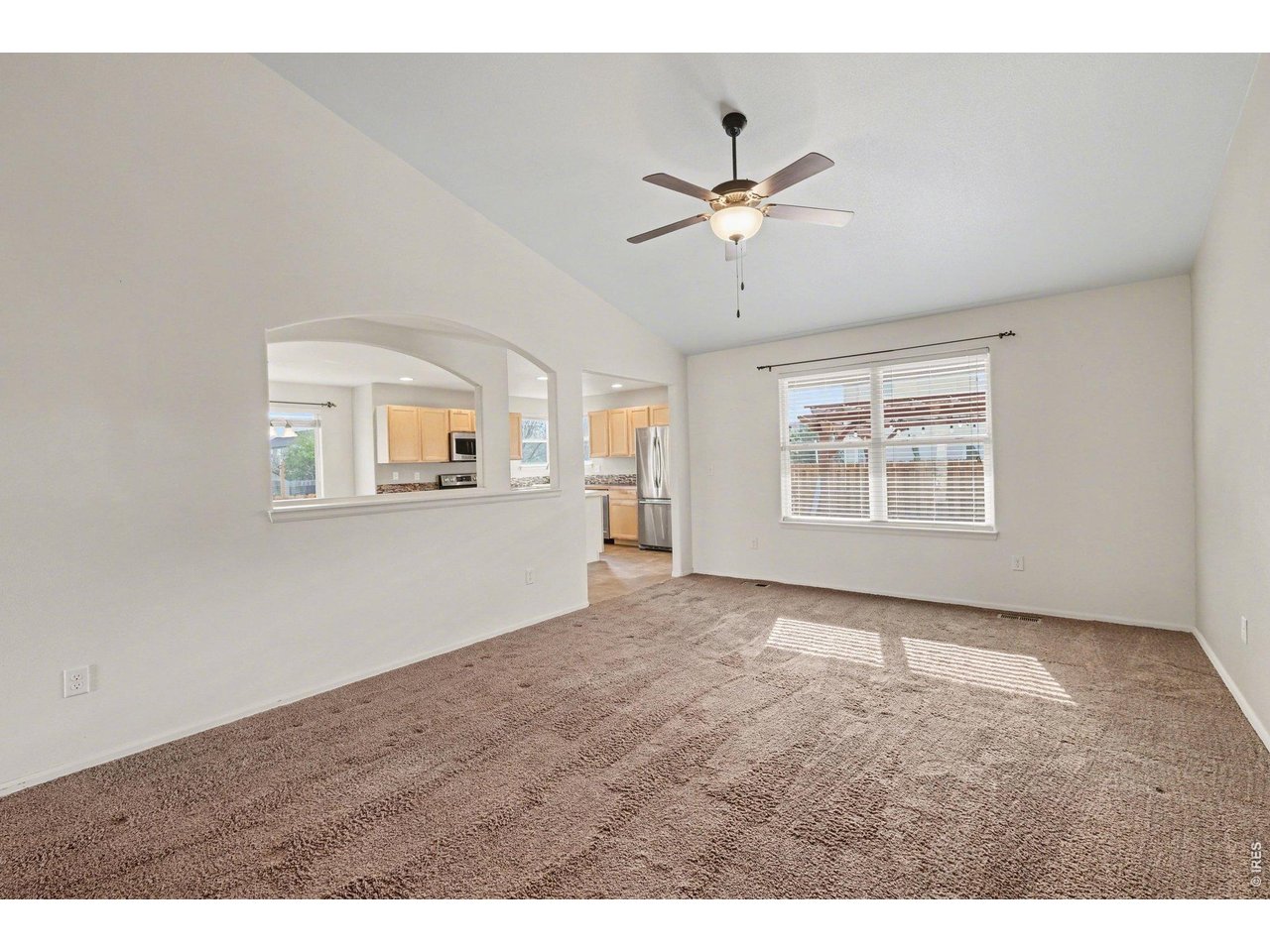 7347 Atlantis Street Wellington, CO 80549 - Photo 3 of 23 Living room has vaulted ceilings