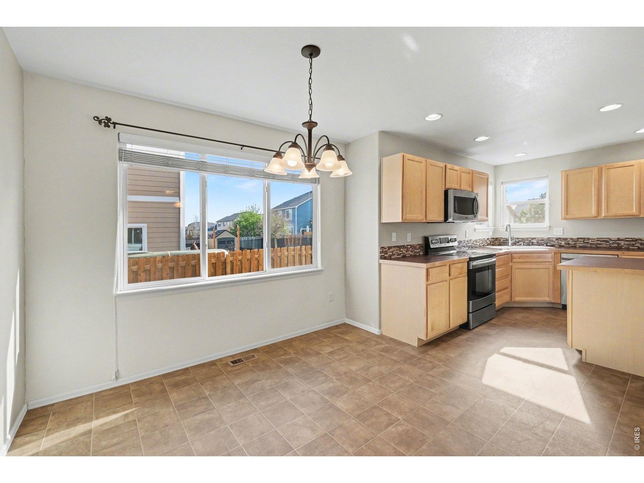 7347 Atlantis Street Wellington, CO 80549 - Photo 7 of 23 Dining room open to kitchen