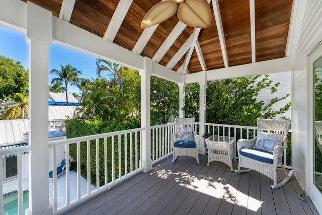 a balcony view with a large window and wooden floor