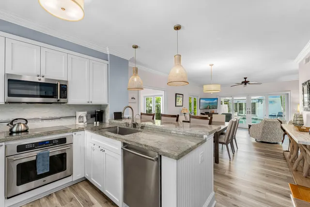 a kitchen with sink stove and microwave