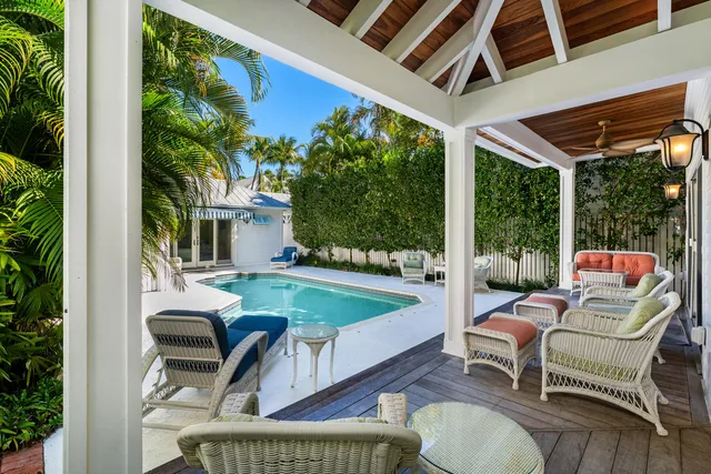 a balcony with furniture and a potted plant