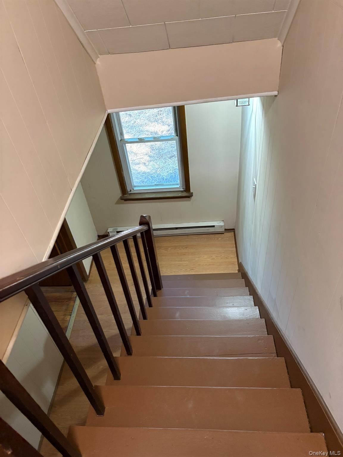 476 Old Rte 17 Livingston Manor, NY 12758 - Photo 23 of 39 Stairway with wood finished floors and a baseboard heating unit