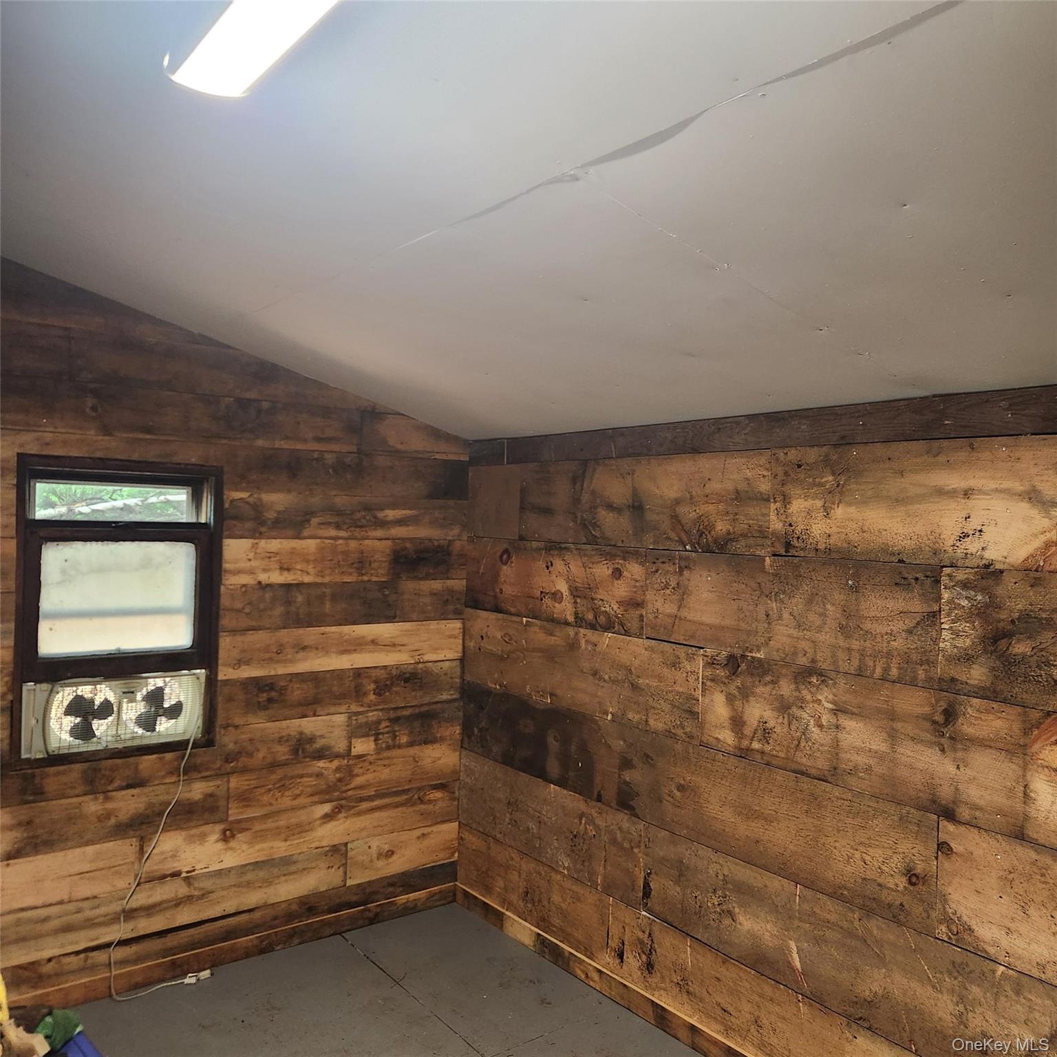 476 Old Rte 17 Livingston Manor, NY 12758 - Photo 29 of 39 Empty Store room featuring wood walls, and concrete floors