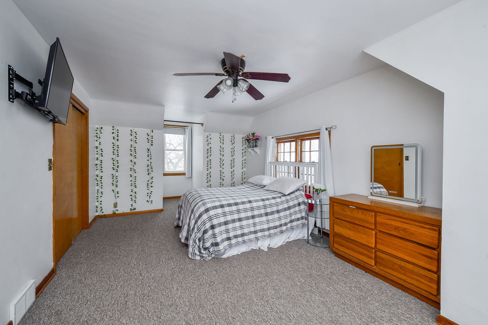 118 Stiles Street Genoa, IL 60135 - Photo 14 of 21 a bedroom with a bed dresser and flat screen tv