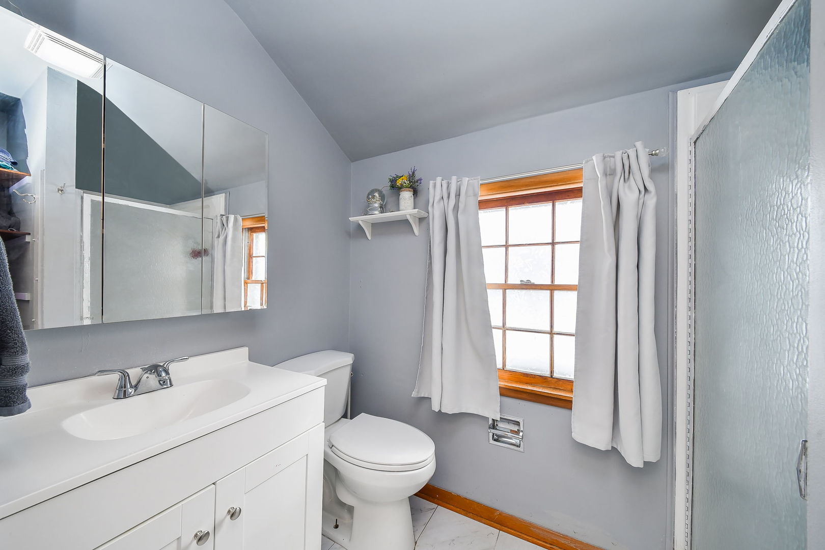 118 Stiles Street Genoa, IL 60135 - Photo 16 of 21 a bathroom with a sink toilet and mirror