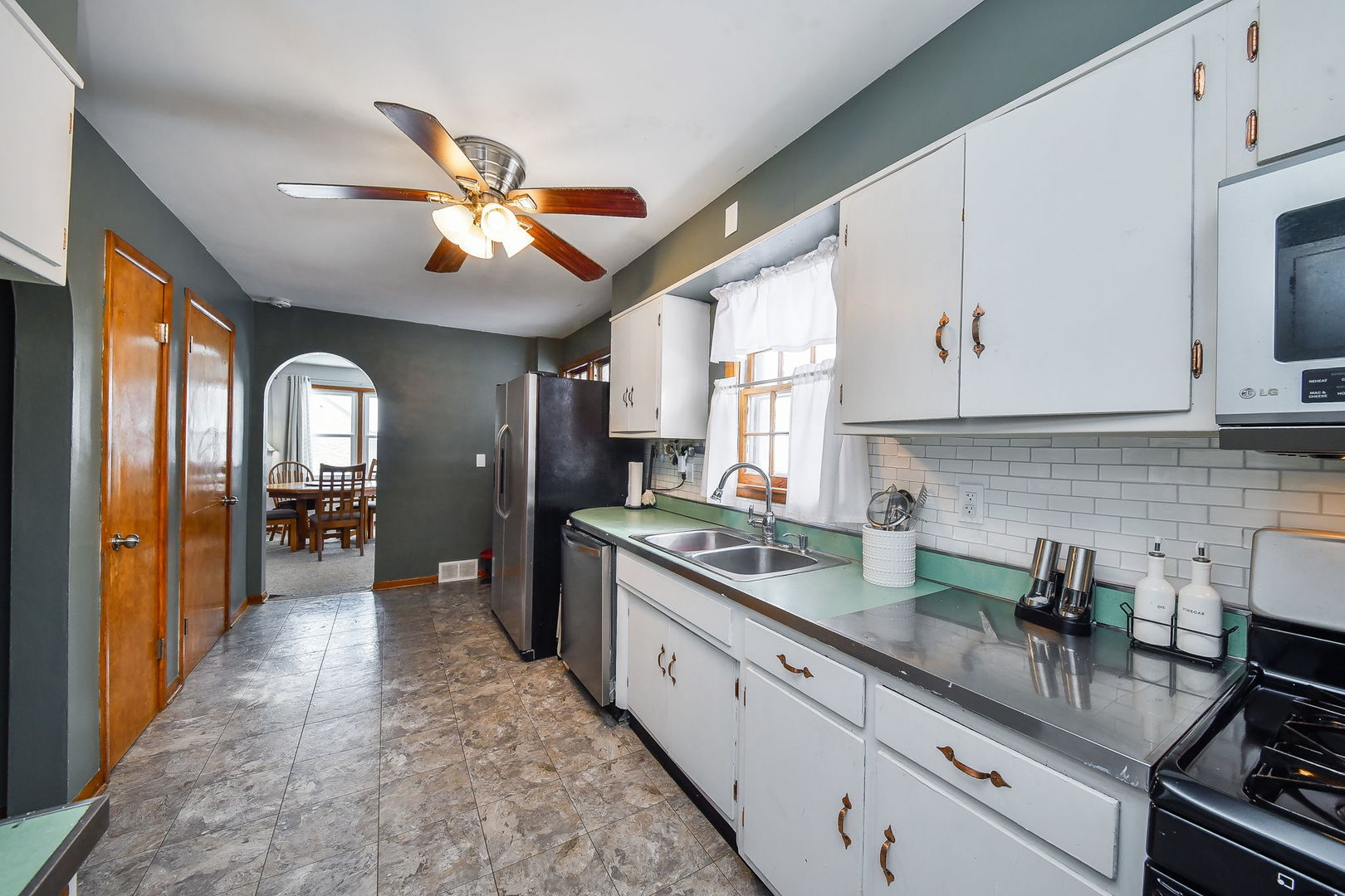 118 Stiles Street Genoa, IL 60135 - Photo 7 of 21 a kitchen with stainless steel appliances granite countertop a sink a stove and cabinets