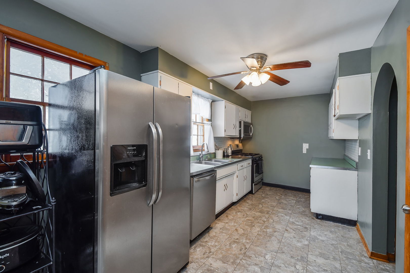 118 Stiles Street Genoa, IL 60135 - Photo 8 of 21 a kitchen with cabinets and stainless steel appliances
