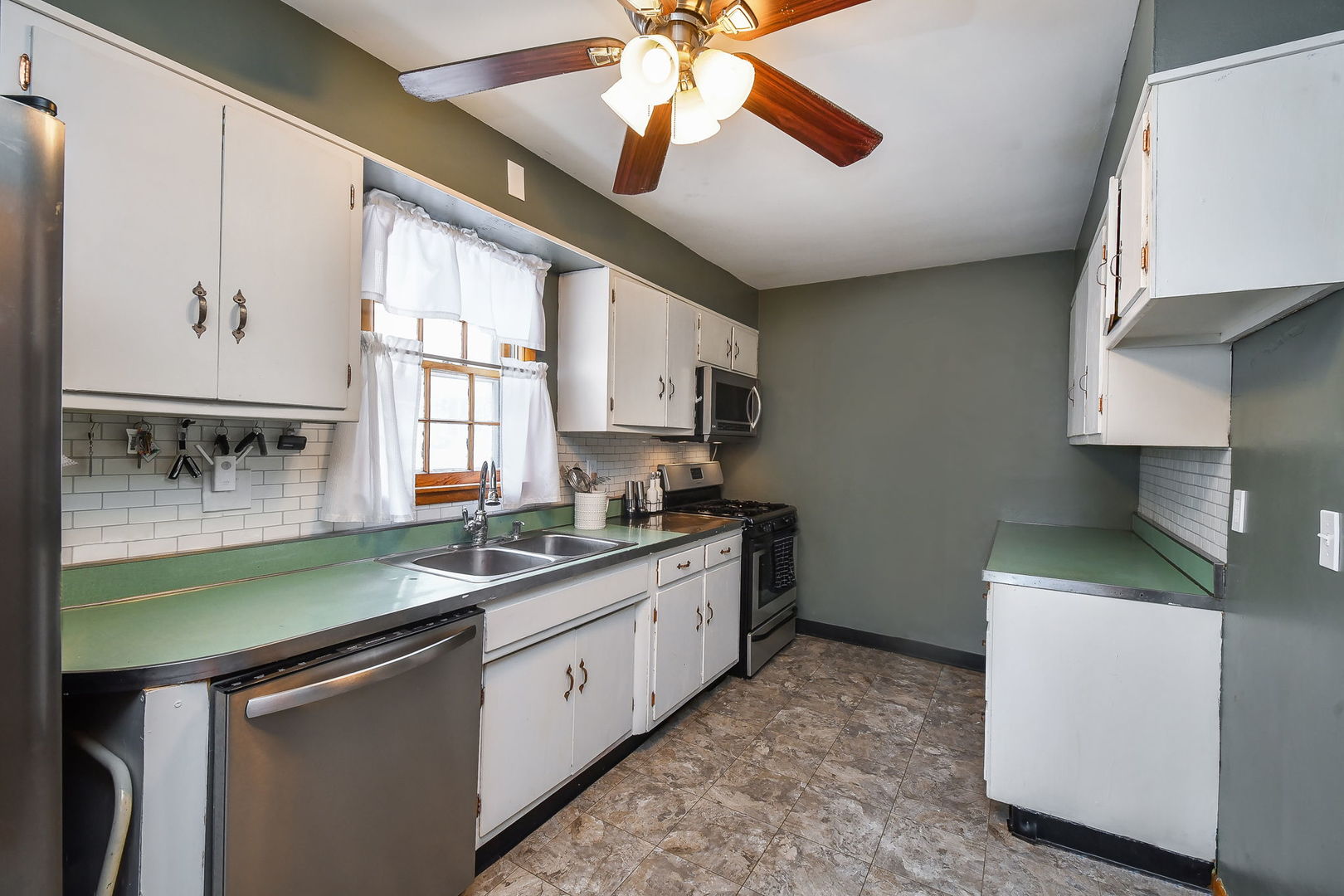 118 Stiles Street Genoa, IL 60135 - Photo 9 of 21 a kitchen with a sink a stove and cabinets