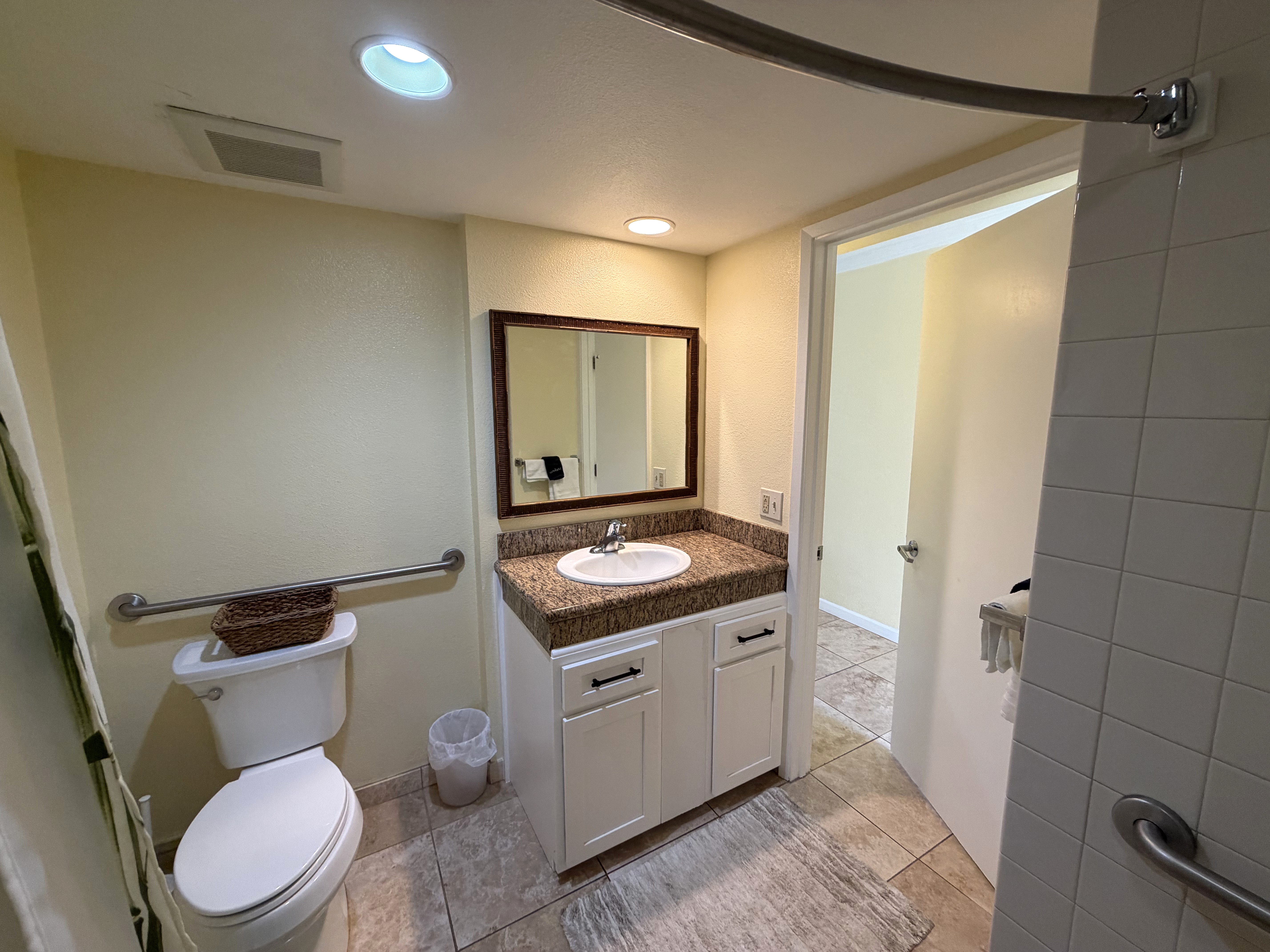 440 Aleka Place, Unit 156 Kapaa, HI 96746 - Photo 12 of 27 a bathroom with a toilet sink and mirror