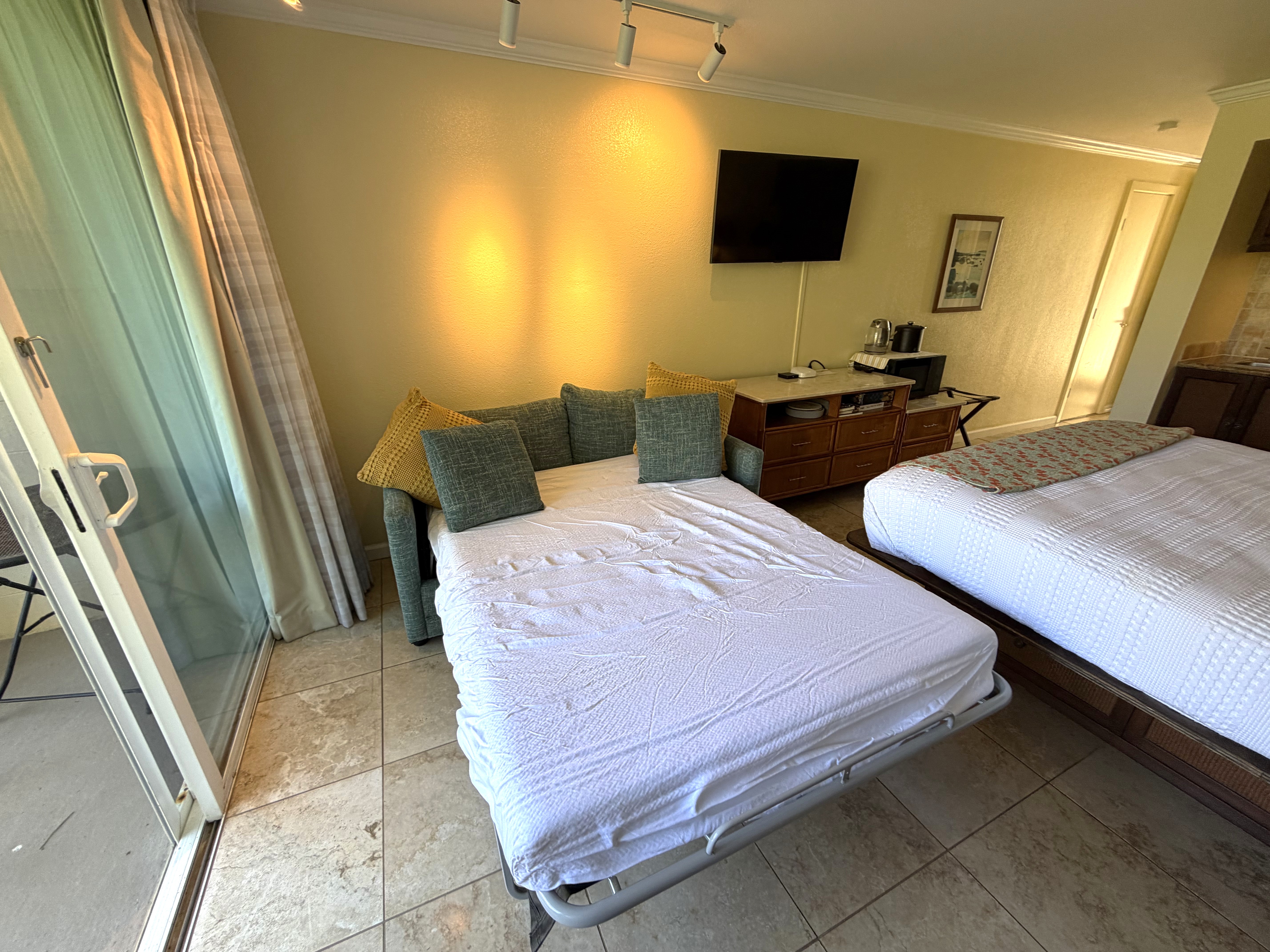 440 Aleka Place, Unit 156 Kapaa, HI 96746 - Photo 27 of 27 a bedroom with two beds and a flat screen tv