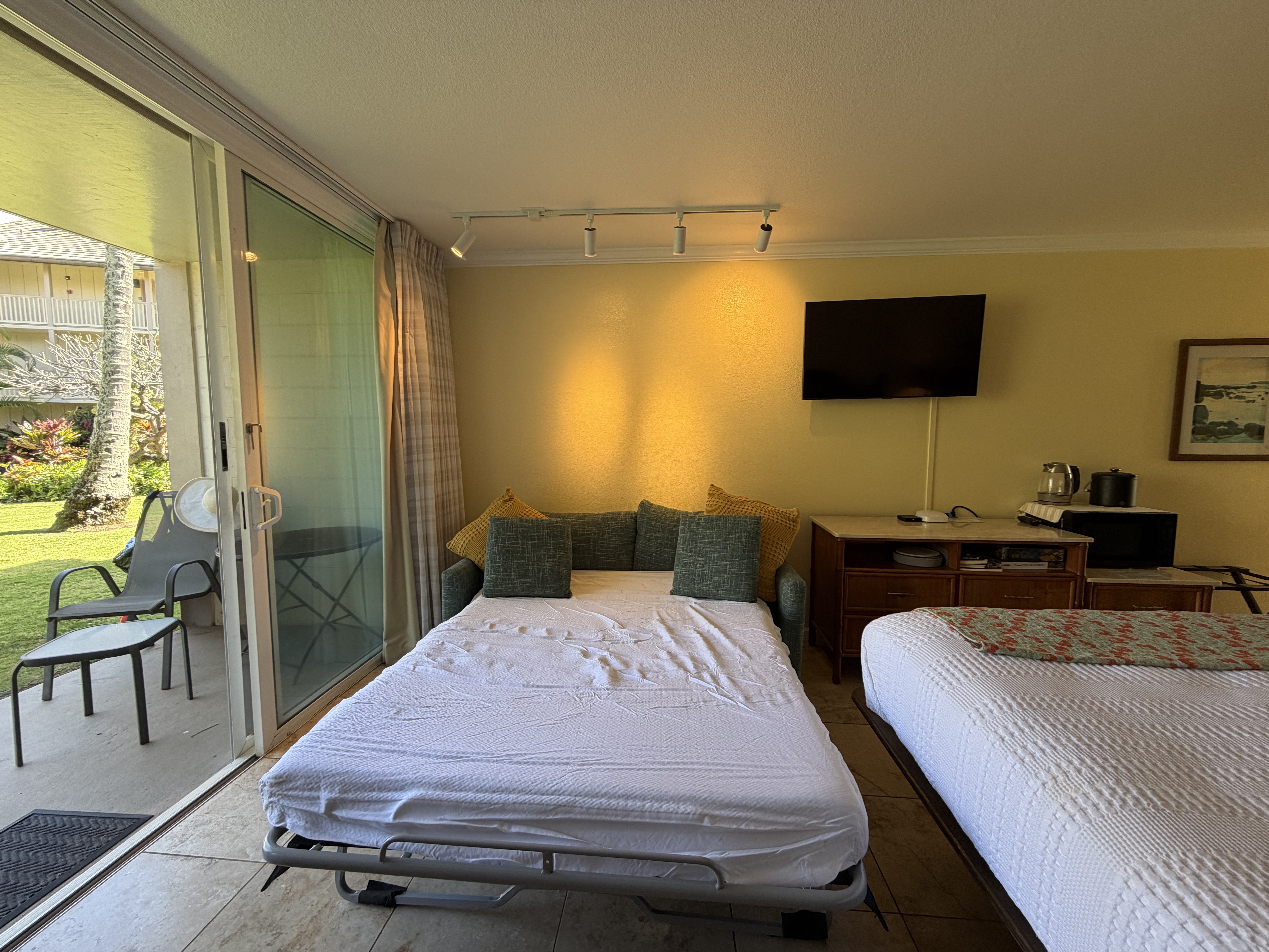 440 Aleka Place, Unit 156 Kapaa, HI 96746 - Photo 6 of 27 a bedroom with a bed and glass wall