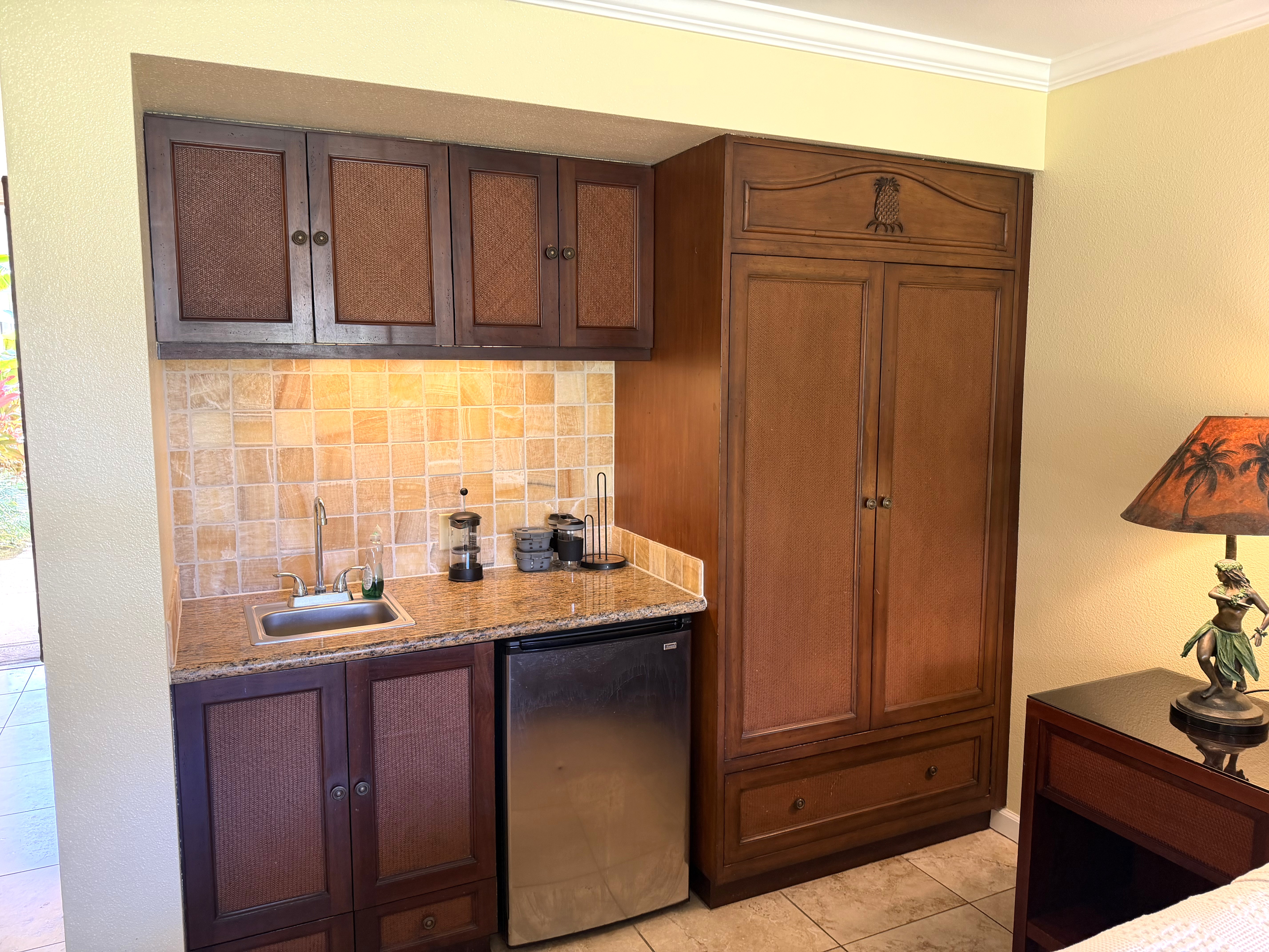 440 Aleka Place, Unit 156 Kapaa, HI 96746 - Photo 7 of 27 a kitchen with granite countertop wooden cabinets and white appliances