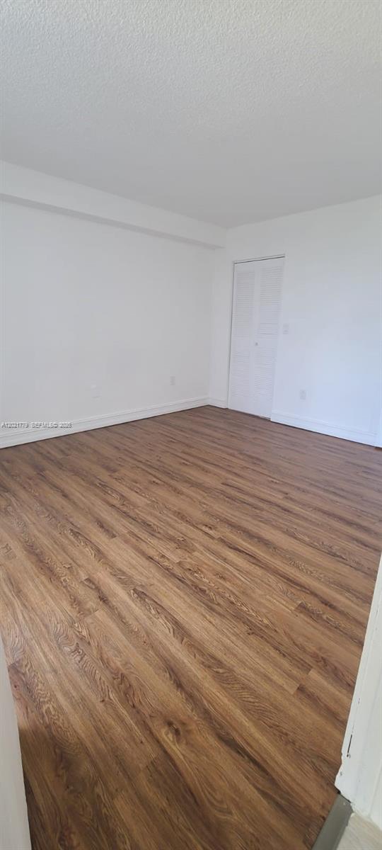 11800 Southwest 18th Street, Unit 4094 Miami, FL 33175 - Photo 13 of 14 a view of an empty room with wooden floor