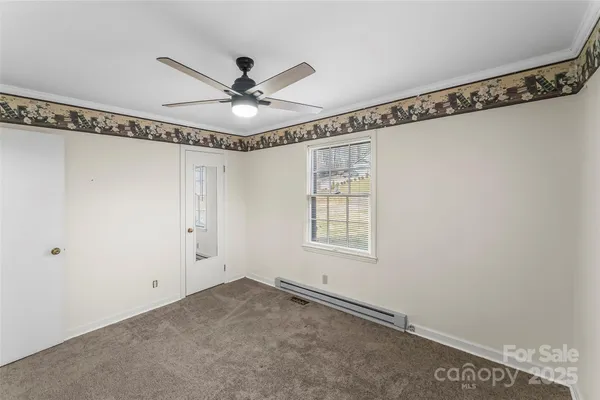 a view of a room with a window and a ceiling fan
