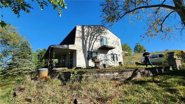 a view of house with outdoor space and swimming pool