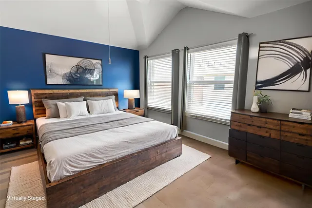 a bedroom with a bed and a painting on the wall