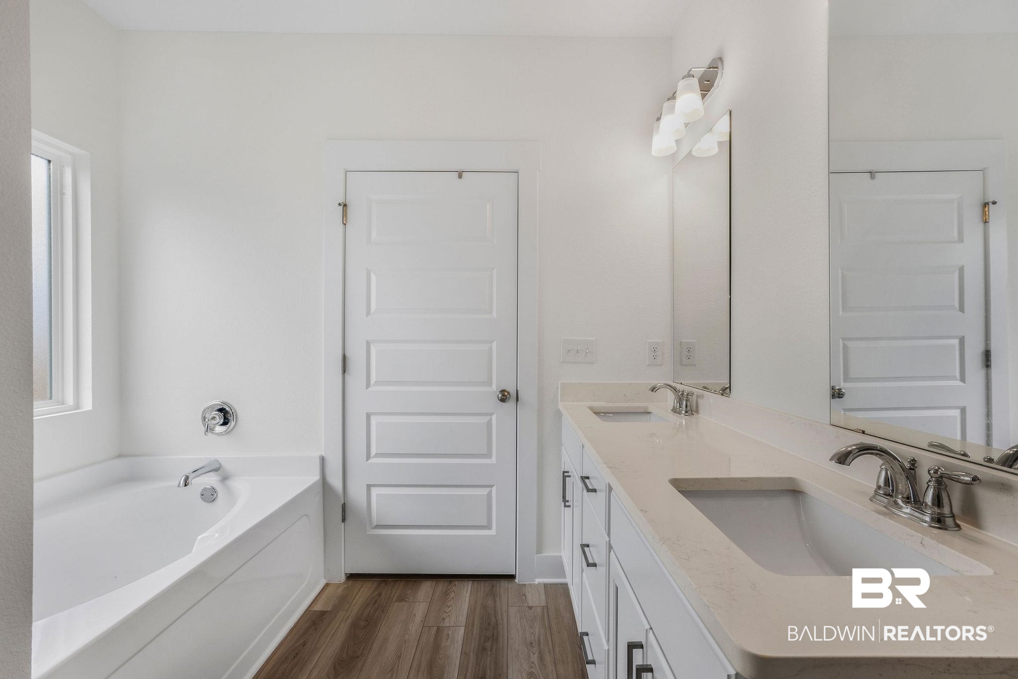 9859 Willet Way Foley, AL 36535 - Photo 13 of 23 Bathroom featuring a bath, double vanity, and dark wood finished floors
