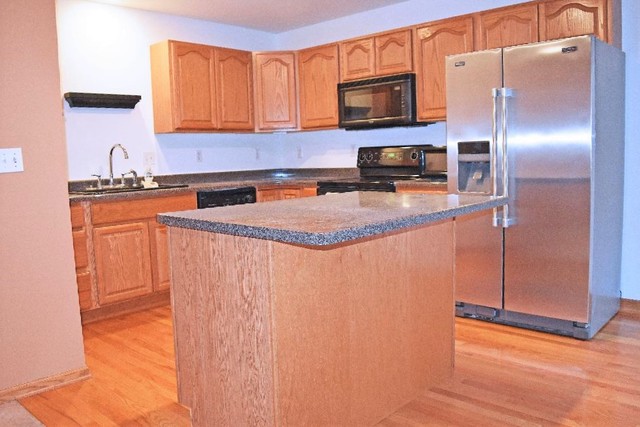 626 South Peace Road Sycamore, IL 60178 - Photo 6 of 24 a kitchen with stainless steel appliances granite countertop a refrigerator a stove a sink and a microwave