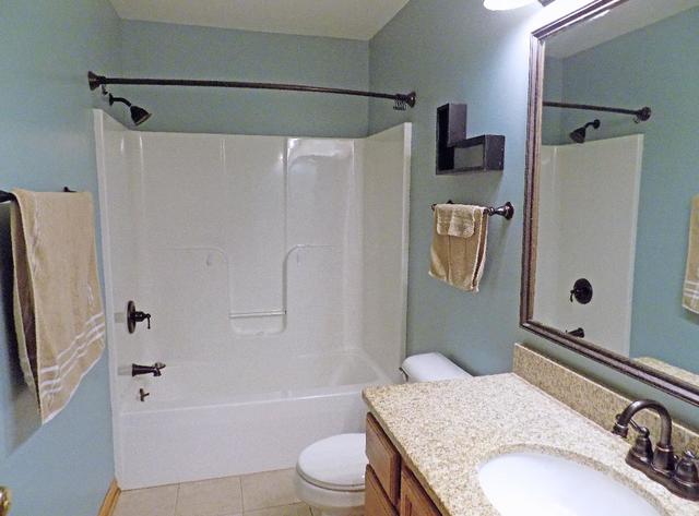 626 South Peace Road Sycamore, IL 60178 - Photo 9 of 24 a bathroom with a granite countertop sink toilet and shower